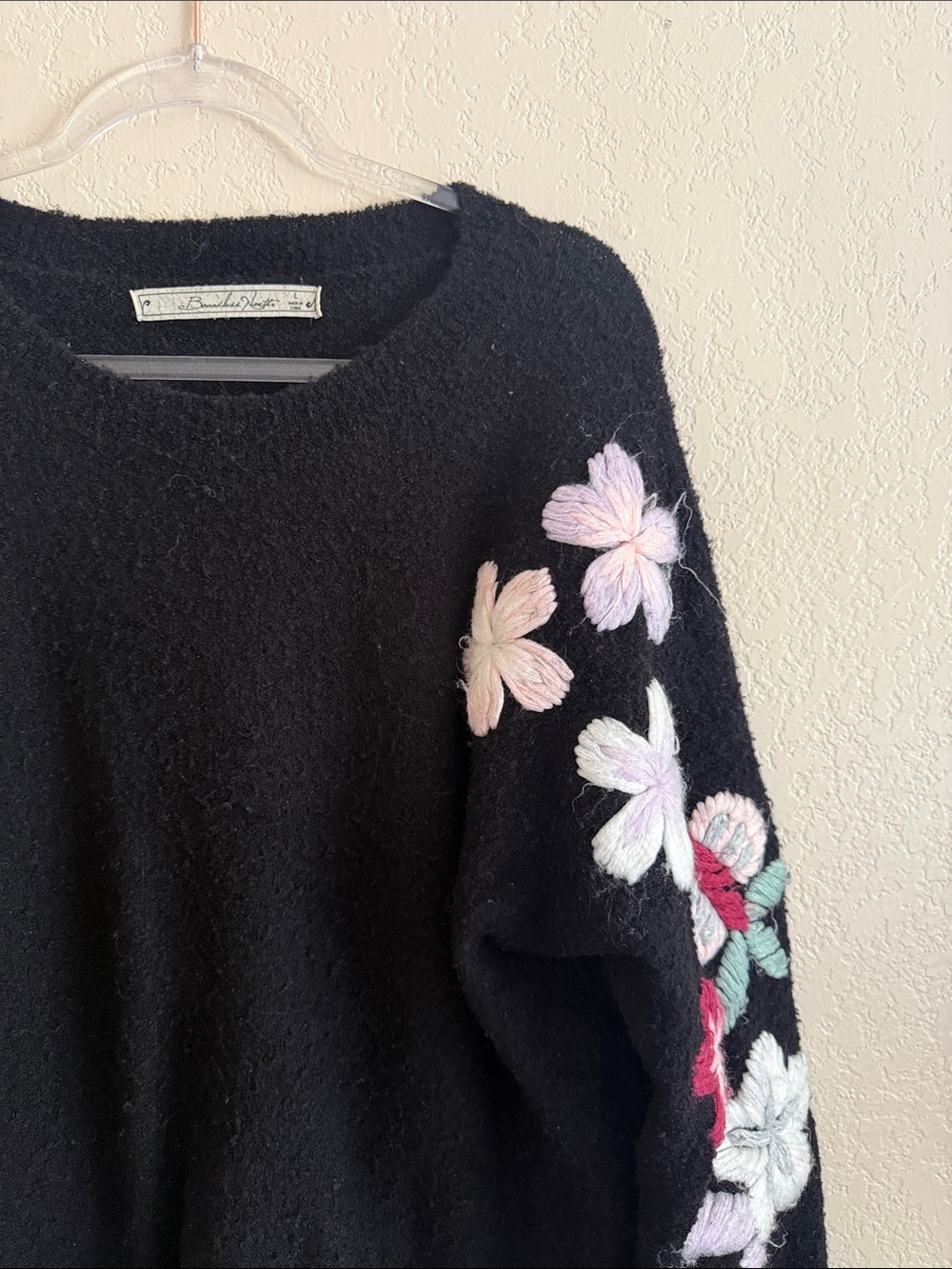 Black Crewneck Sweater with Pastel Floral Appliqué